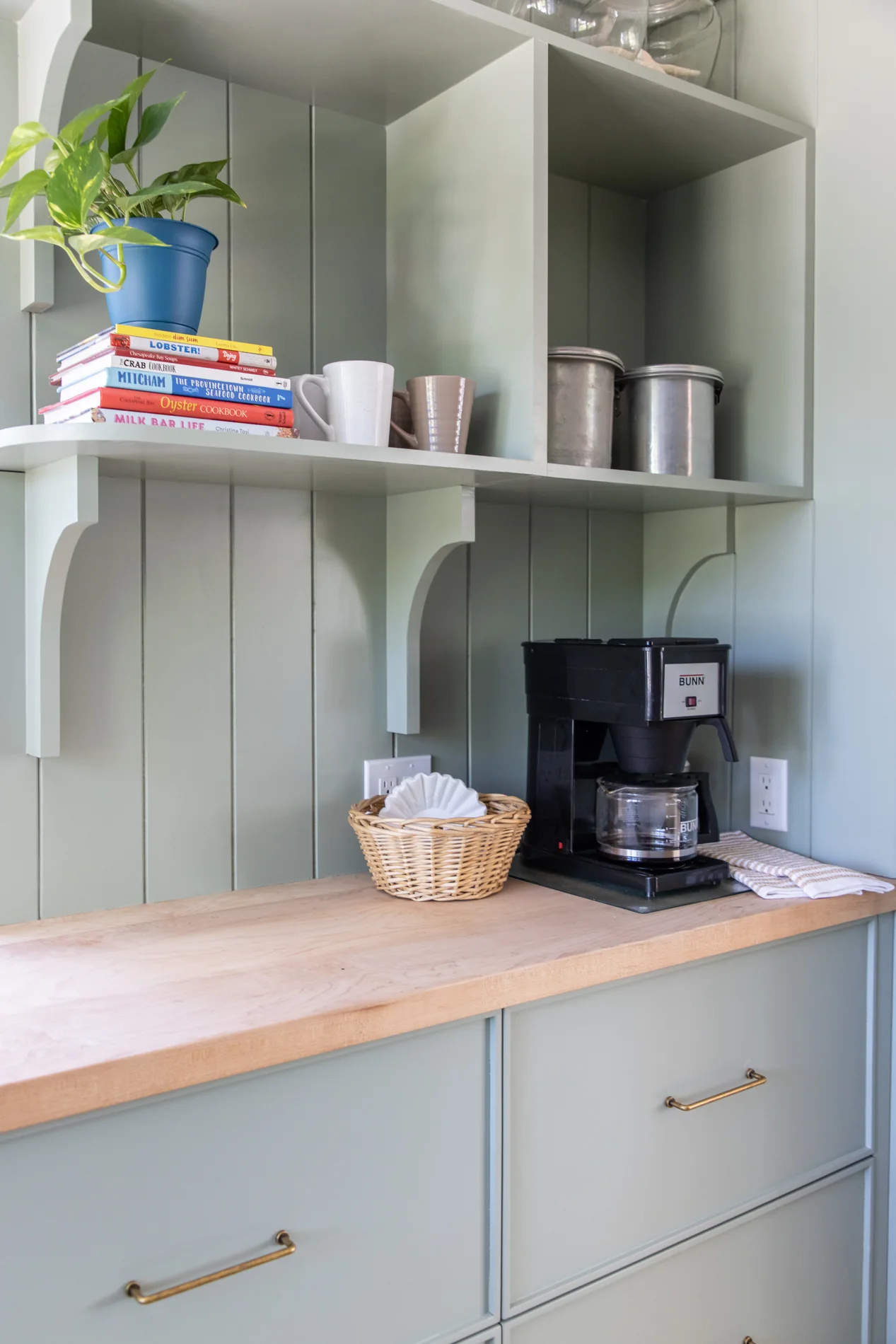 Sage coffee station with open shelving and wood counter