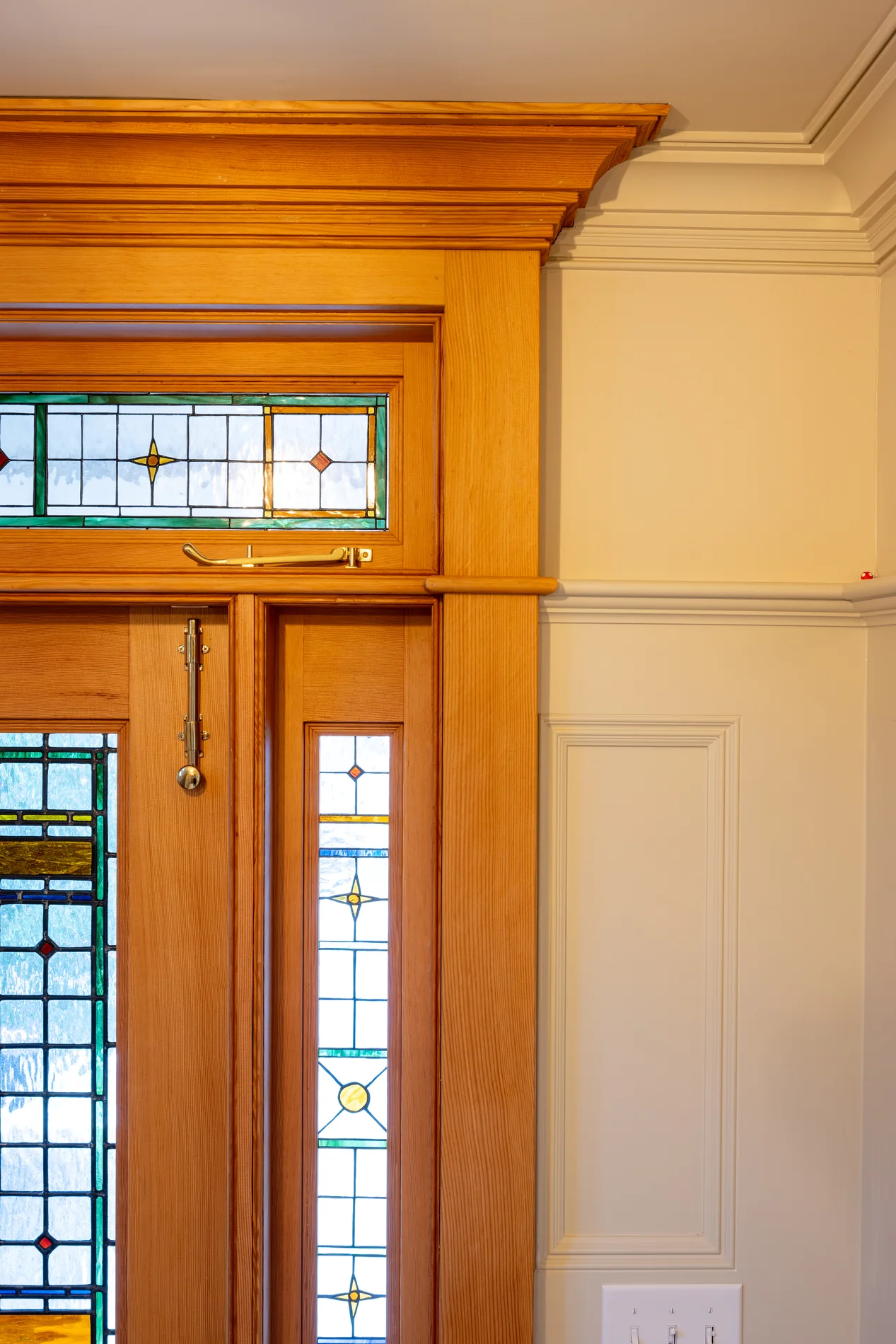 Wood door casing with decorative glass transom